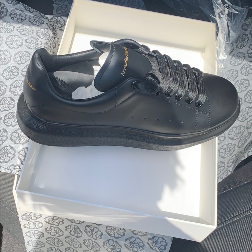 Alexander McQueens all black leather shoes.